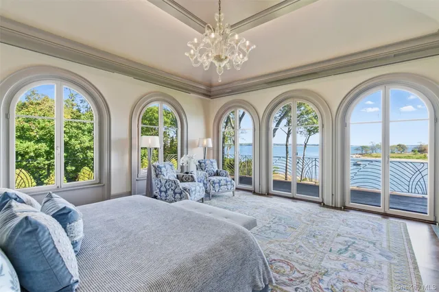 a spacious bedroom with furniture and a fireplace