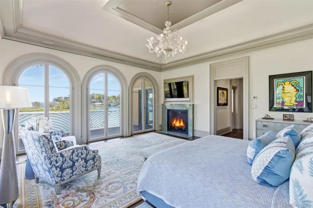 a spacious bathroom with a large window and a chandelier