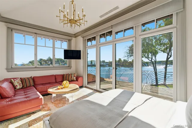 a bedroom with a bed and glass window