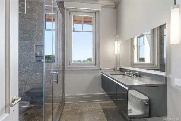 a living room with furniture a flat screen tv and a floor to ceiling window