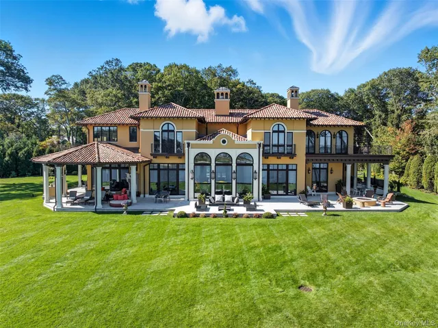 a view of an outside dining space with furniture and garden