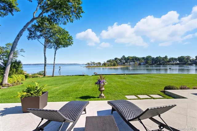 a view of a living room with a floor to ceiling window and kitchen
