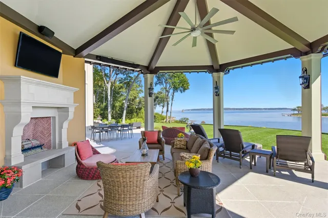 a view of a lake with furniture and garden