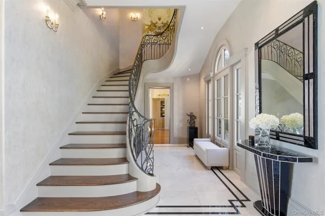 a living room with furniture and a chandelier