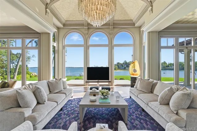 a living room with couches a fireplace and a flat screen tv