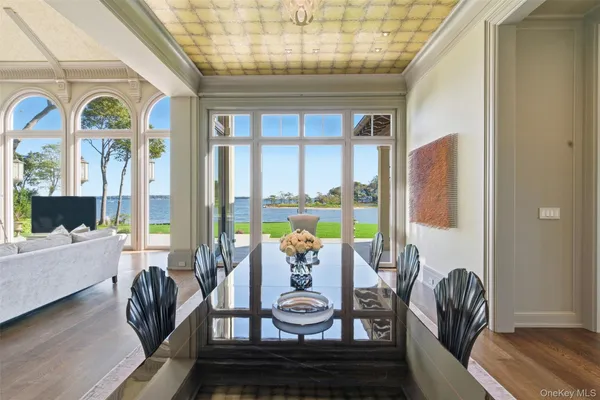 a view of a dining room with furniture a chandelier and wooden floor