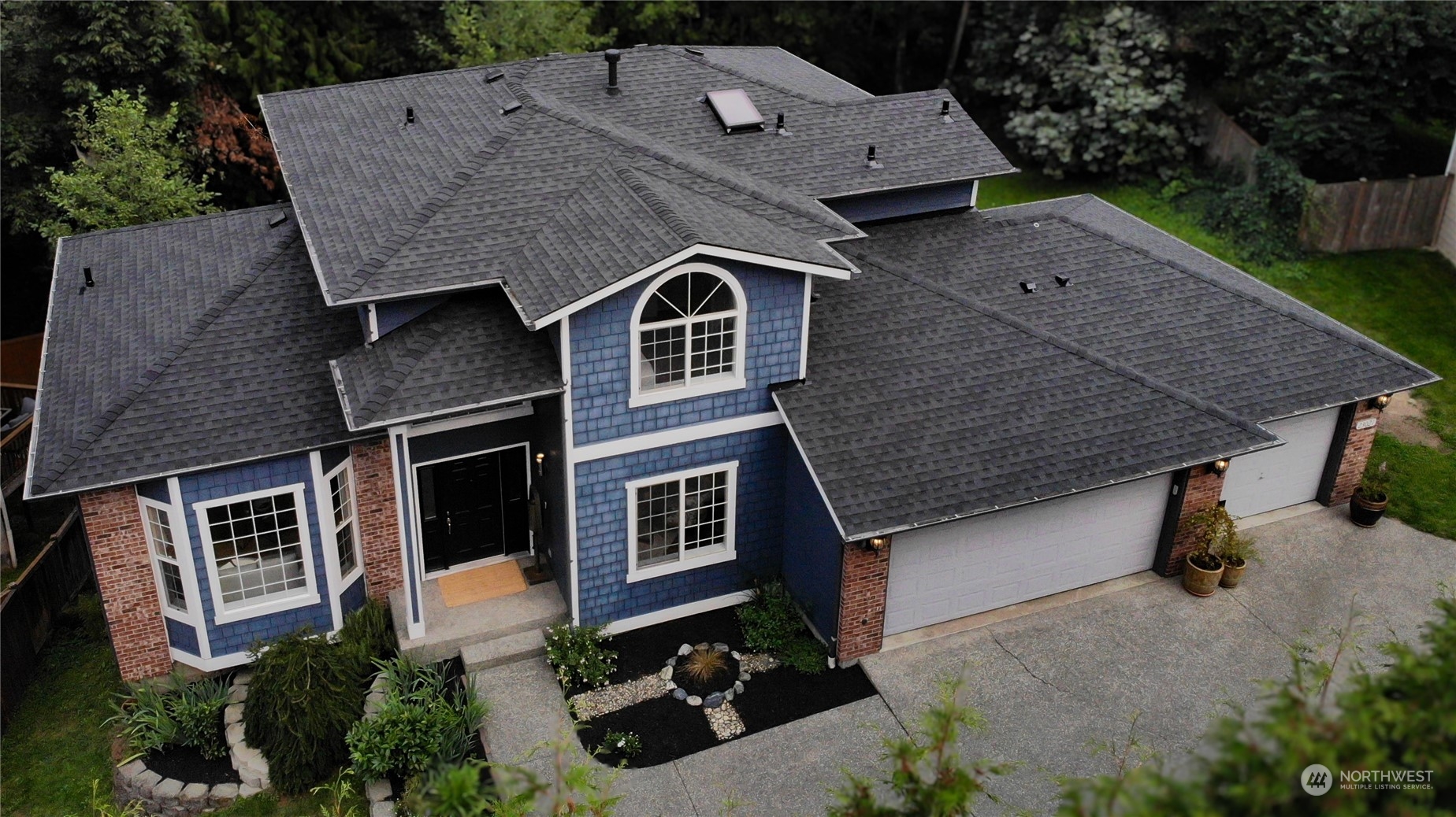 an aerial view of a house with a yard
