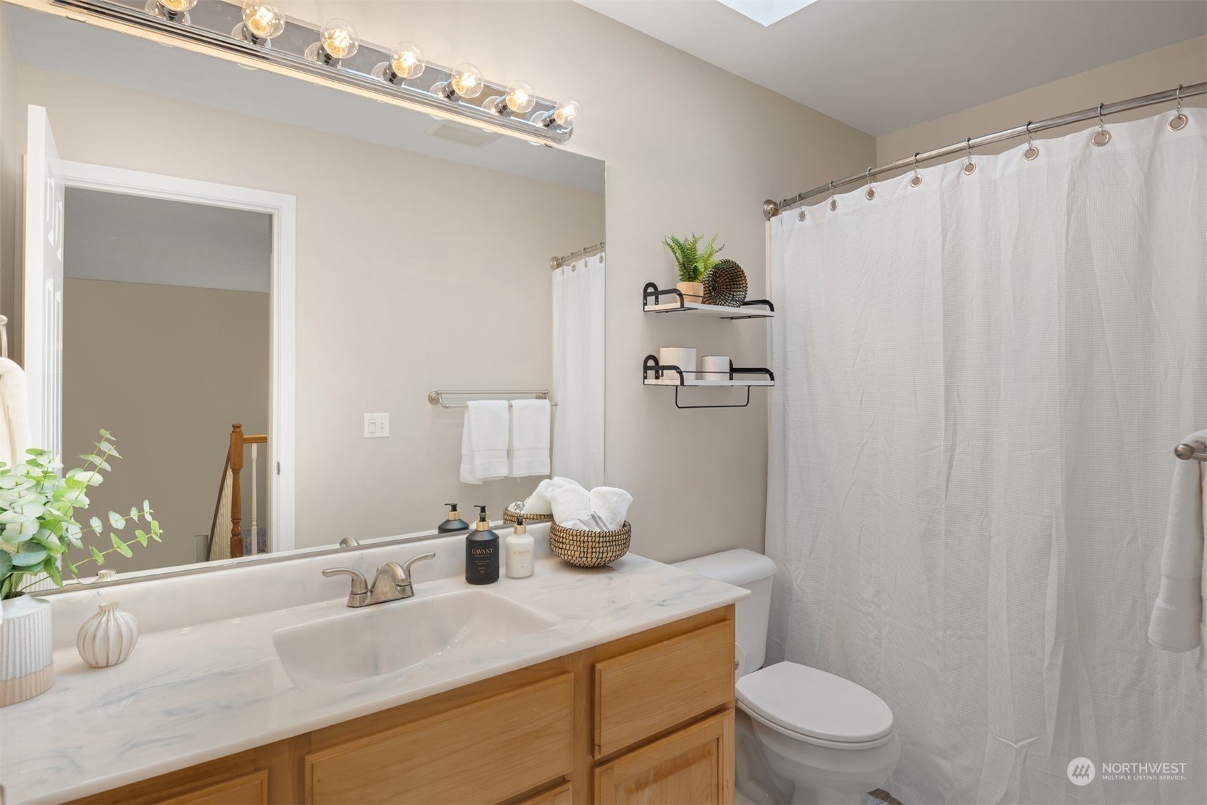 23021 21st Avenue Southeast Bothell, WA 98021 - Photo 20 of 29 a bathroom with a sink a toilet a mirror and shower
