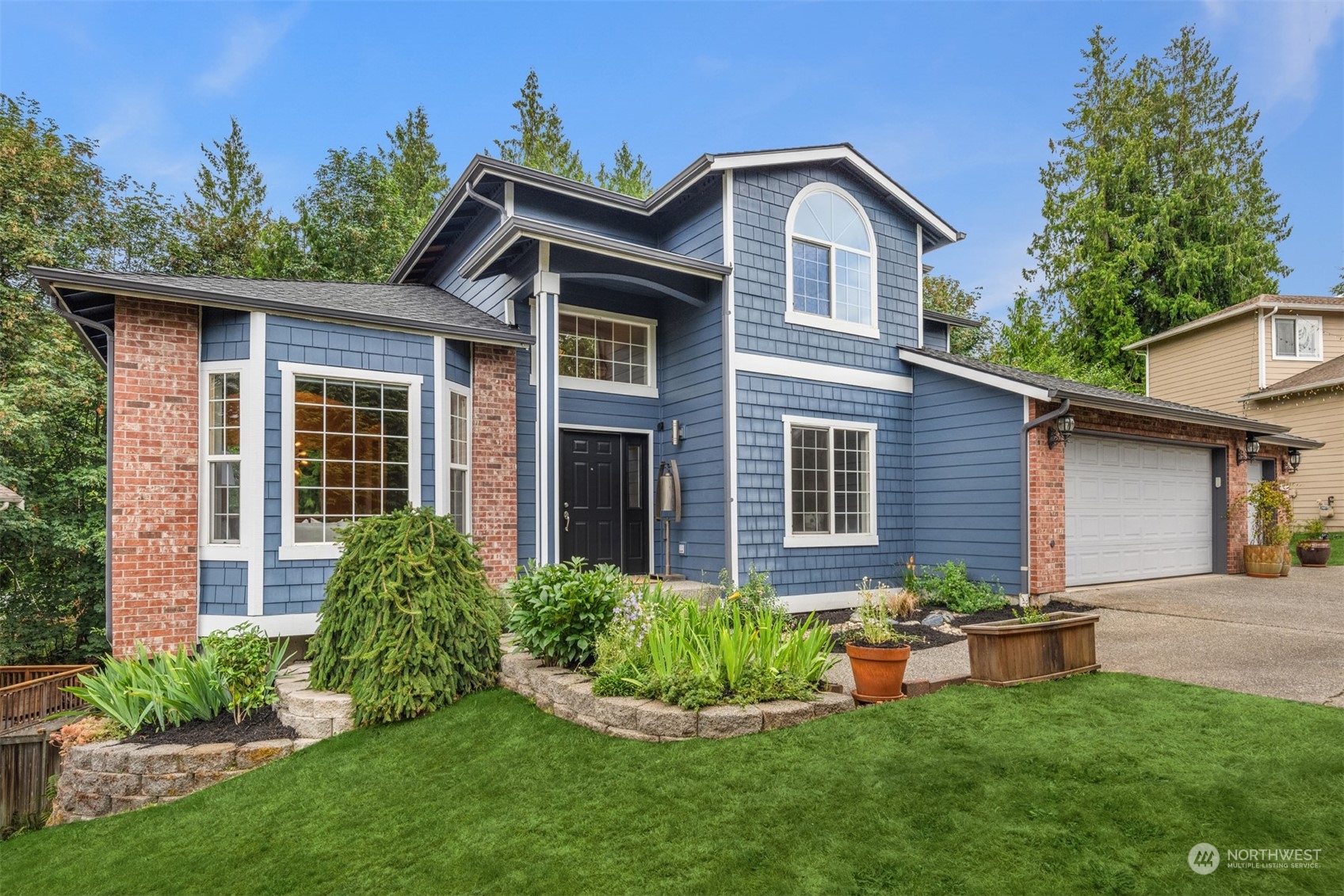 23021 21st Avenue Southeast Bothell, WA 98021 - Photo 29 of 29 a front view of a house with a yard and garage