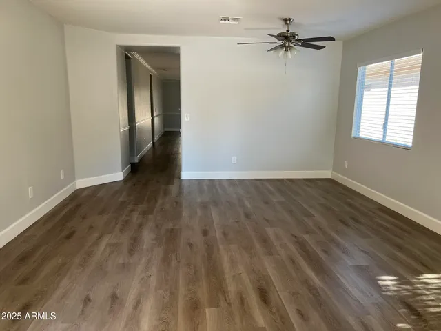 wooden floor in an empty room with a window