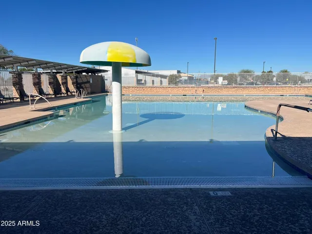 a view of a swimming pool with a table under an umbrella