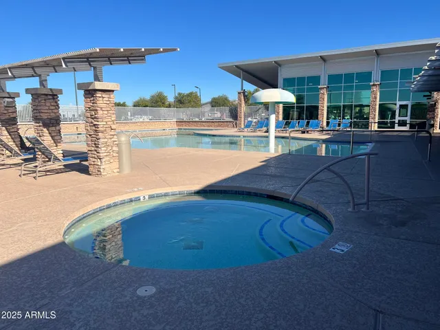a view of a swimming pool with a lounge chairs