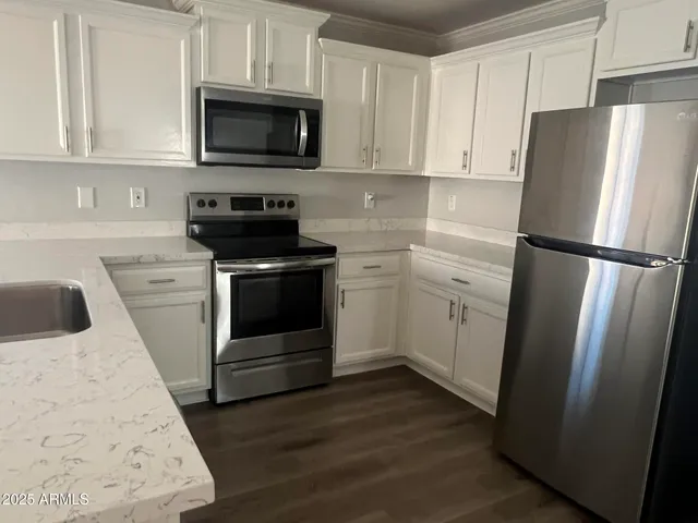 a kitchen with a refrigerator stove and microwave