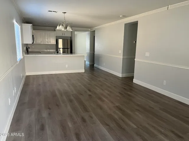 a view of a kitchen with wooden floor and a sink