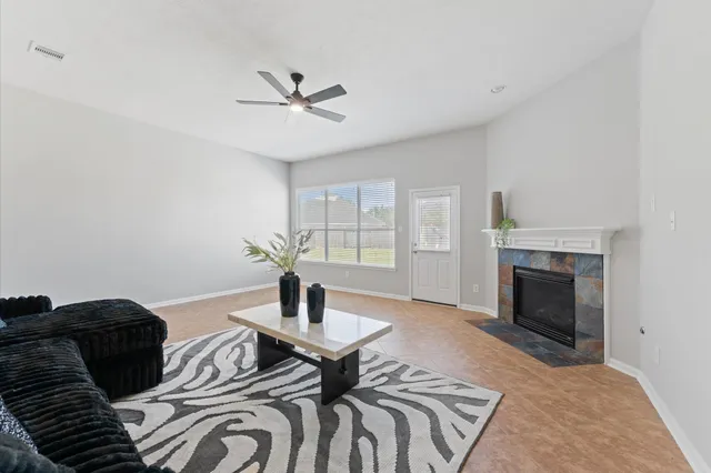 a living room with furniture and a fireplace