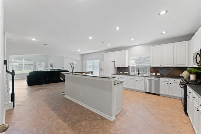 a large kitchen with cabinets and a counter top space