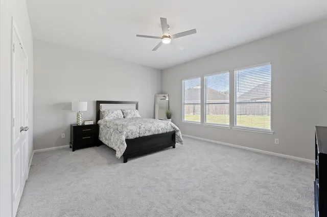 a bedroom with a bed and window