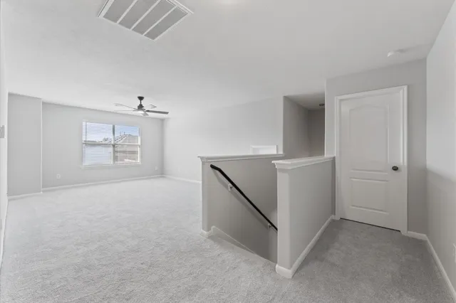 an empty room with windows and entrance