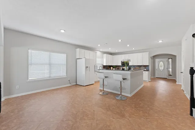 a view of a kitchen with refrigerator and windows