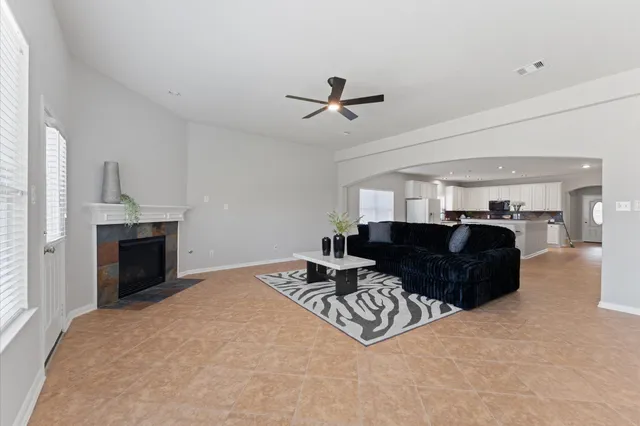 a living room with furniture a fireplace and a flat screen tv