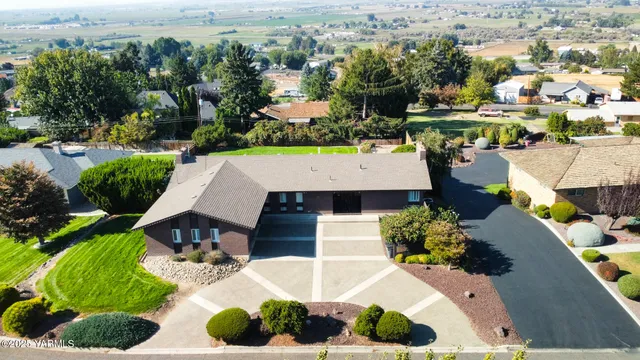 an aerial view of a house with yard swimming pool and outdoor seating