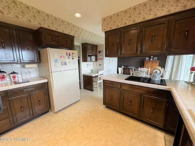 a kitchen with sink cabinets and refrigerator