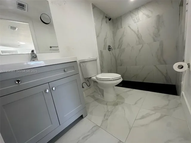 a bathroom with a sink a toilet and a bathtub