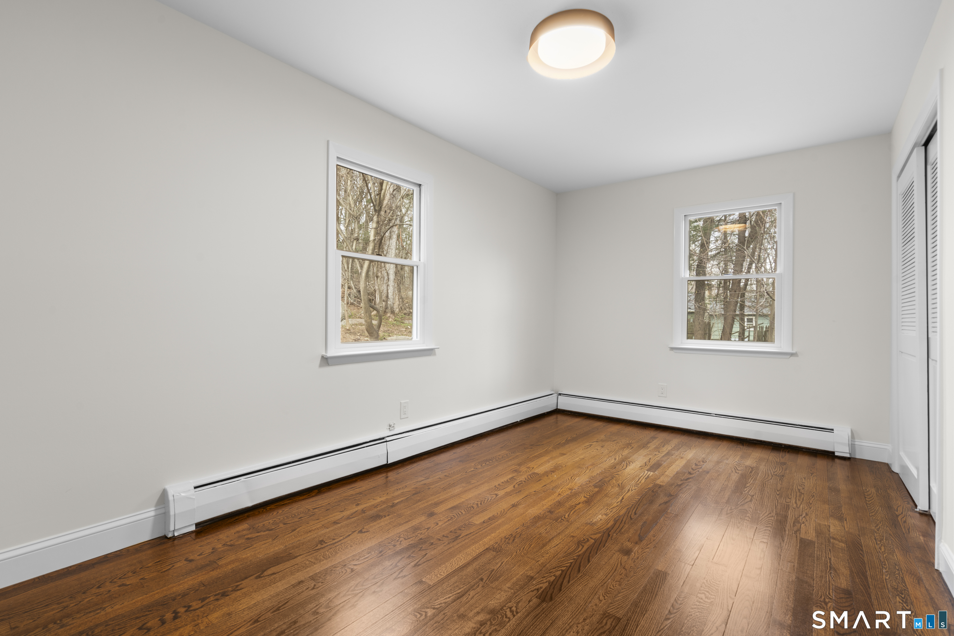 70 Dayton Road Redding, CT 06896 - Photo 11 of 38 an empty room with wooden floor and windows