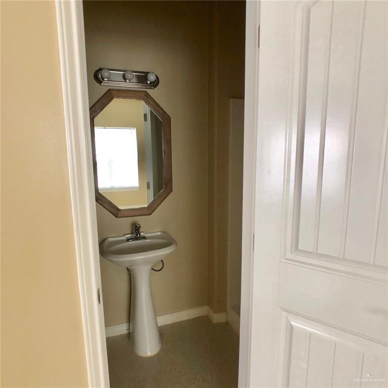 804 North Taylor Road, Unit 29 Mission, TX 78572 - Photo 11 of 27 a bathroom with a sink a mirror and bathtub