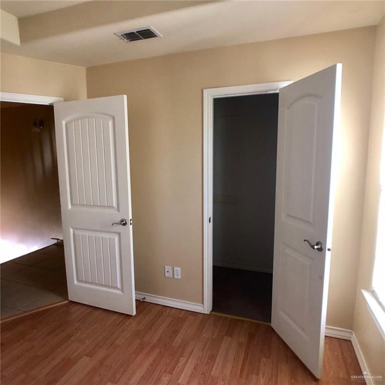 804 North Taylor Road, Unit 29 Mission, TX 78572 - Photo 18 of 27 a view of an empty room with wooden floor and closet
