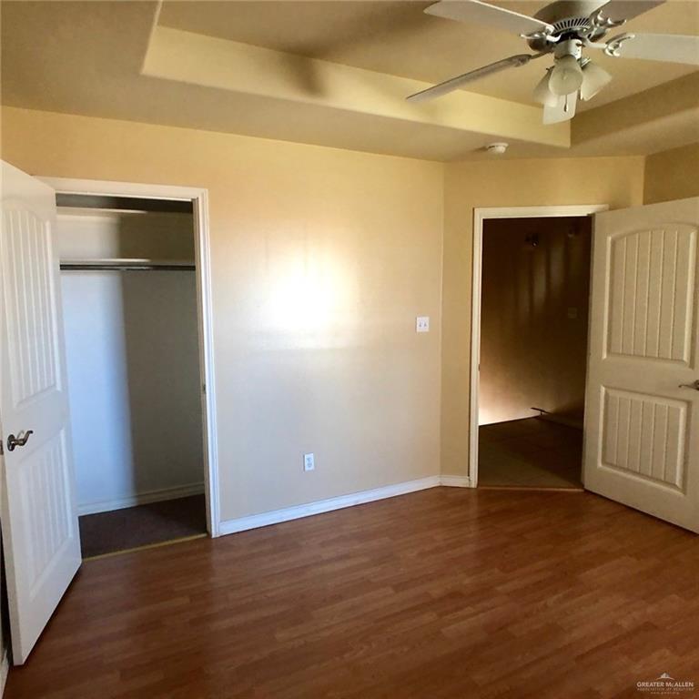 804 North Taylor Road, Unit 29 Mission, TX 78572 - Photo 19 of 27 an empty room with wooden floor closet and windows