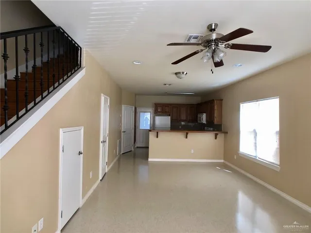 a view of a livingroom with a window and a ceiling fan