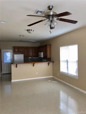 a view of a livingroom with furniture and a window