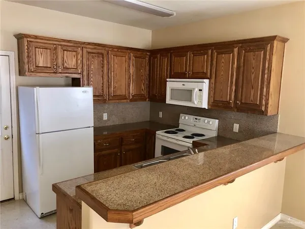 a kitchen with a refrigerator a stove a sink and a cabinets