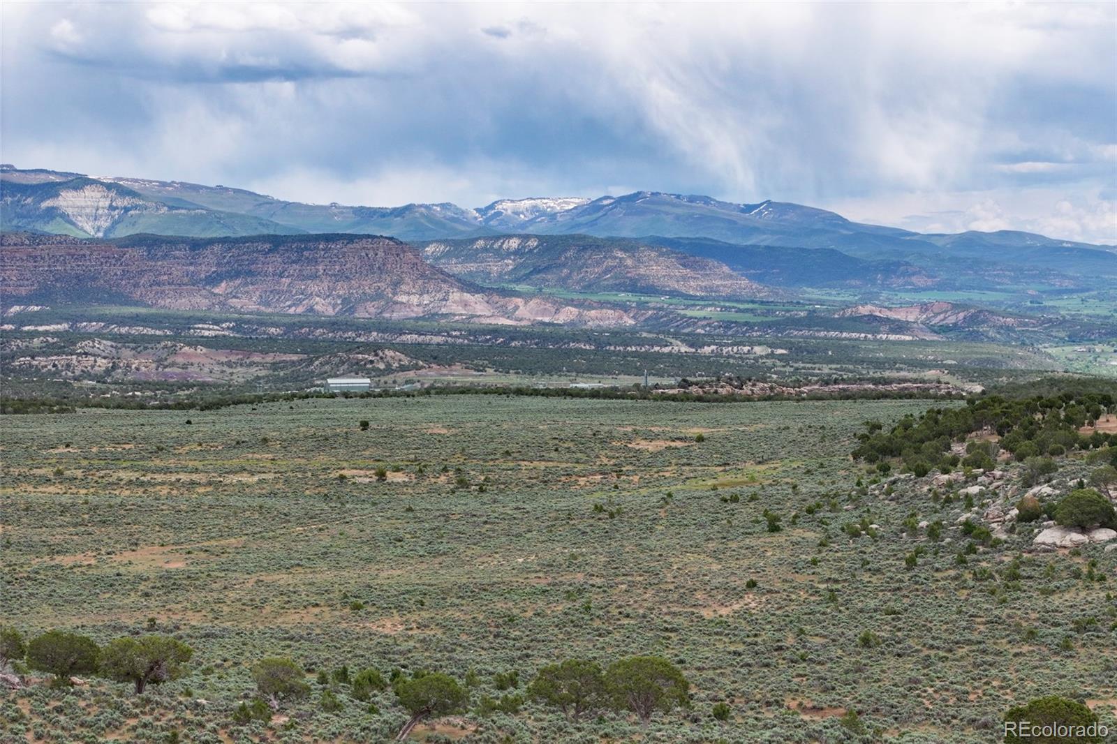 0 Tbd De Beque, CO 81630 - Photo 3 of 6 a view of a lake with mountains in the background
