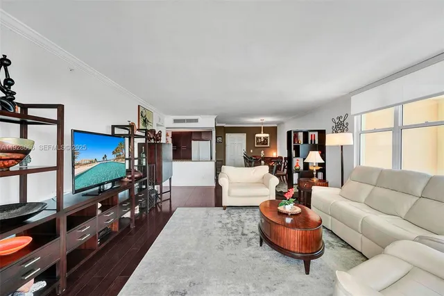 a kitchen with stainless steel appliances granite countertop a table chairs and a refrigerator