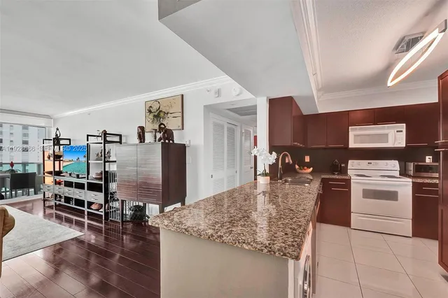a kitchen with a refrigerator and a sink