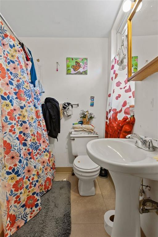 107 Overbrook Boulevard Pittsburgh, PA 15210 - Photo 18 of 33 a white toilet sitting next to a sink and a tub