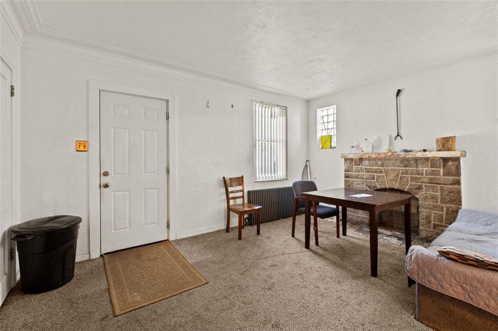 107 Overbrook Boulevard Pittsburgh, PA 15210 - Photo 23 of 33 a living room with furniture a fireplace and a table