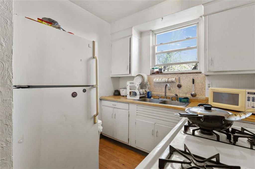 107 Overbrook Boulevard Pittsburgh, PA 15210 - Photo 26 of 33 a kitchen with a refrigerator a stove a sink and a cabinets