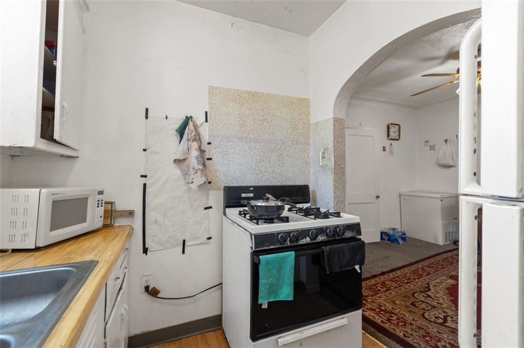 107 Overbrook Boulevard Pittsburgh, PA 15210 - Photo 27 of 33 a kitchen with stainless steel appliances granite countertop a stove and a sink