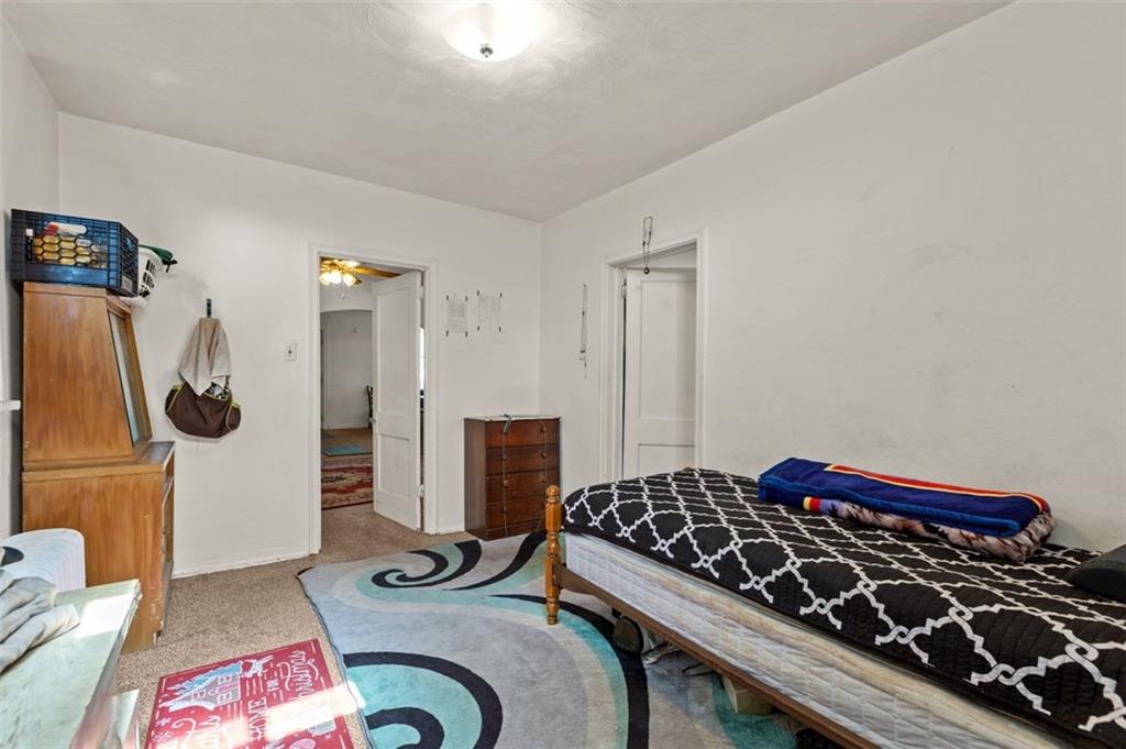 107 Overbrook Boulevard Pittsburgh, PA 15210 - Photo 32 of 33 a bedroom with a bed and a table in it