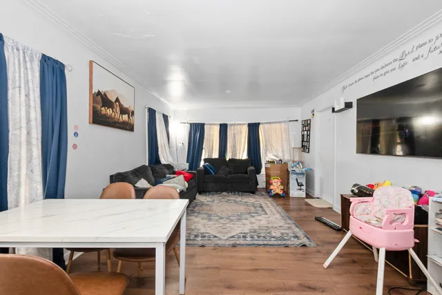 a very nice looking living room with a large window and a flat screen tv
