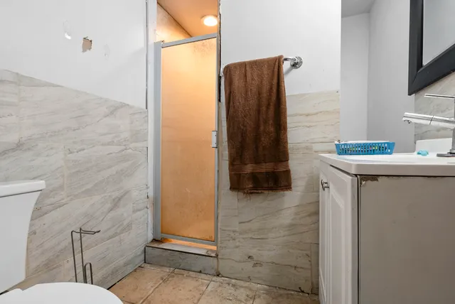 a bathroom with a sink toilet and shower