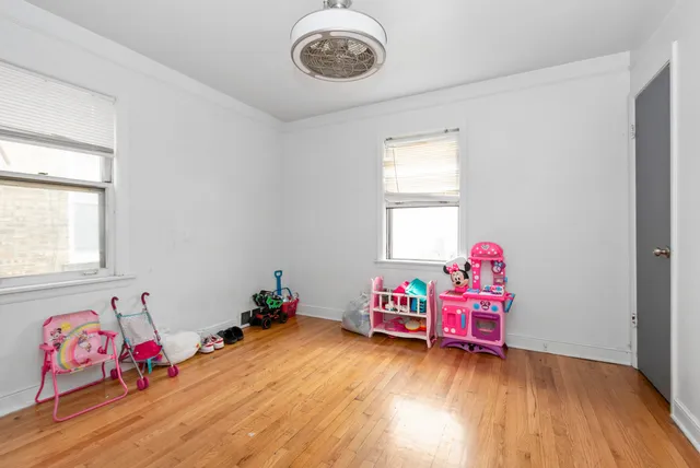 a view of a room with toys and wooden floor