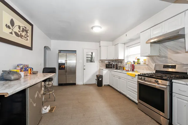 a kitchen with stainless steel appliances a stove refrigerator sink and cabinets