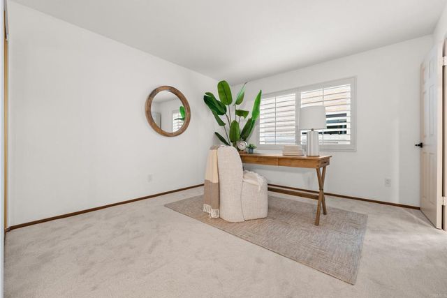 a view of a dining room with furniture and a potted plant