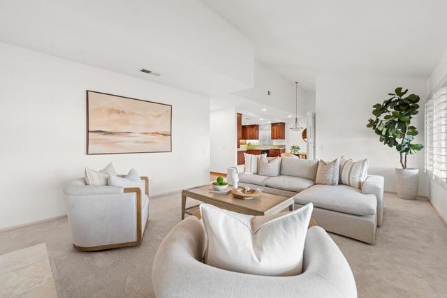 a kitchen with stainless steel appliances kitchen island granite countertop a stove a sink and a white cabinets