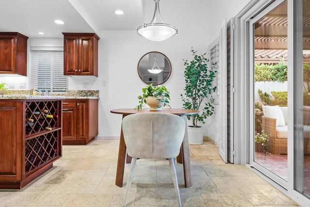 a kitchen with stainless steel appliances granite countertop a refrigerator a stove a sink and a oven