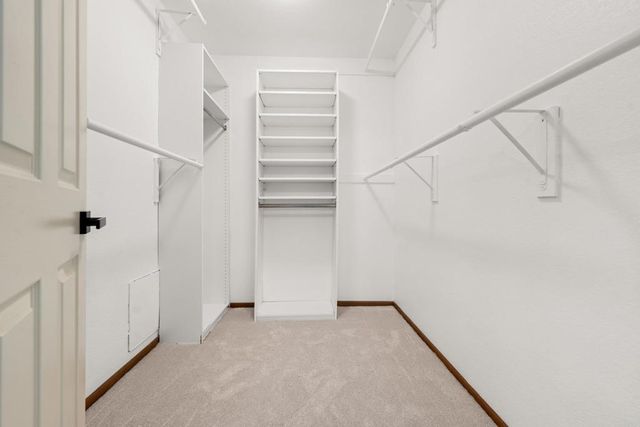 a spacious bathroom with a granite countertop sink a mirror and a